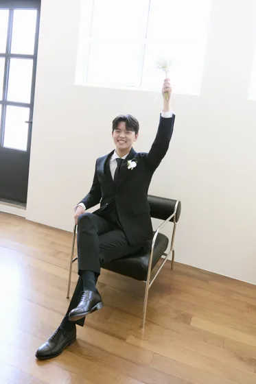 부케를 높이 들고 웃는 신랑